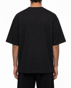 Plain back of the black Belarté Odyssey Warrior T-shirt on a model