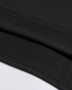 Close-up of the double-stitched hem on the black Belarté Six Seven T-shirt